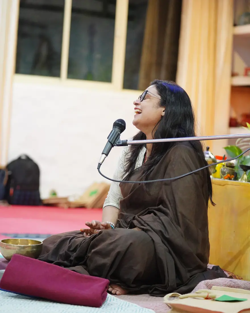 Dr. Sonali Mishra teaching, seated with a microphone
